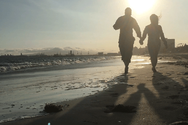 couple walking along the beach in long beach created by me medium