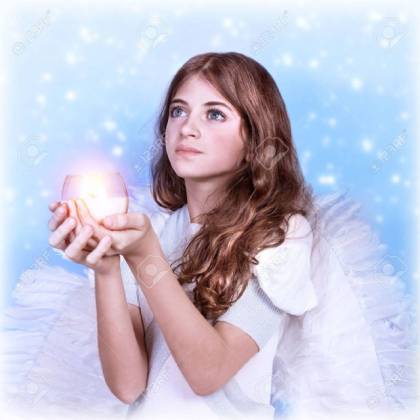 closeup portrait of cute little angel looking up holding candle medium
