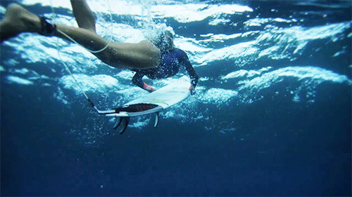 the dope surf society underwater gif of a girl surfer duck diving medium