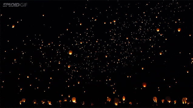 watching lanterns fly up into the night sky is awe inspiring night medium