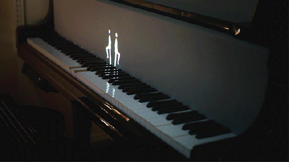 projected figures of humans and animals play the keyboard through small